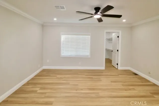 an empty room with fan and window