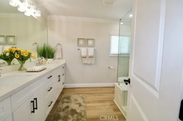 a bathroom with a double vanity sink and mirror
