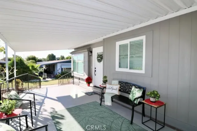 a living room filled with furniture and a potted plant