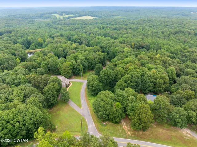 an aerial view of a houses with a yard