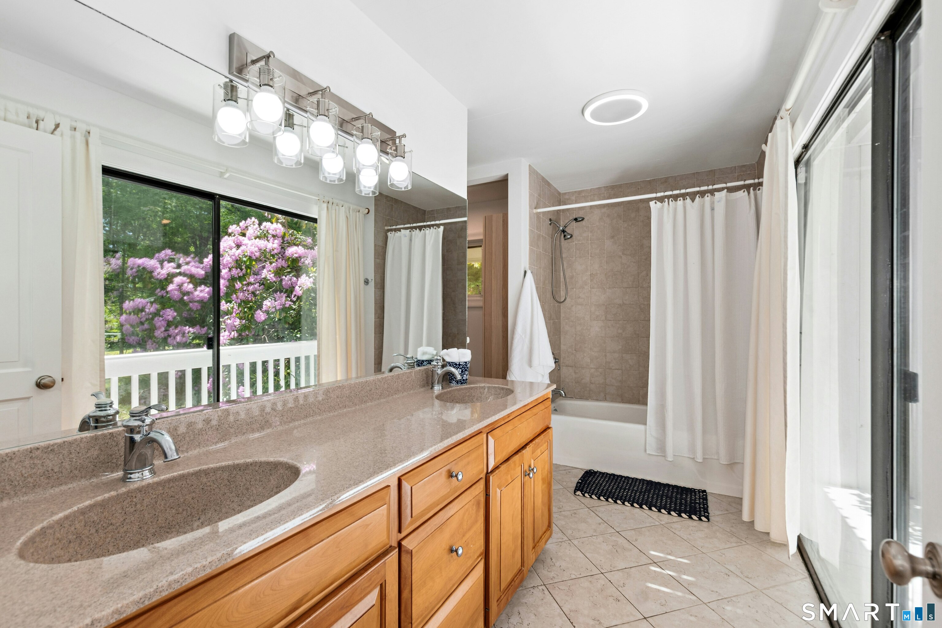 38 Old Redding Road Weston, CT 06883 - Photo 17 of 40 The Primary Bathroom is sunlit and has double sinks, tub/shower, a sauna, and sliders to the exterior balcony.