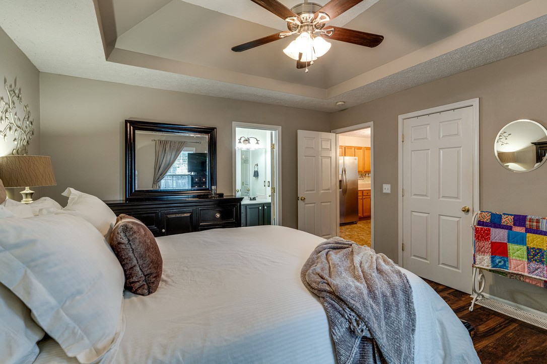 908 Chesire Court White House, TN 37188 - Photo 11 of 20 a bedroom with a bed and a chandelier