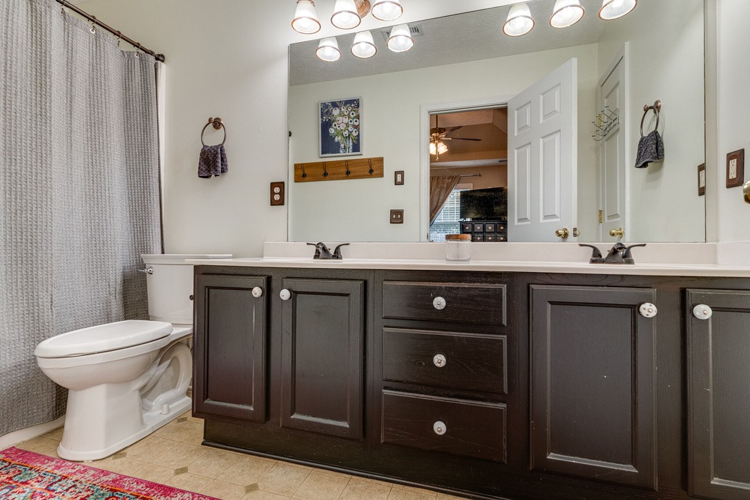 908 Chesire Court White House, TN 37188 - Photo 12 of 20 a bathroom with a toilet a sink and mirror