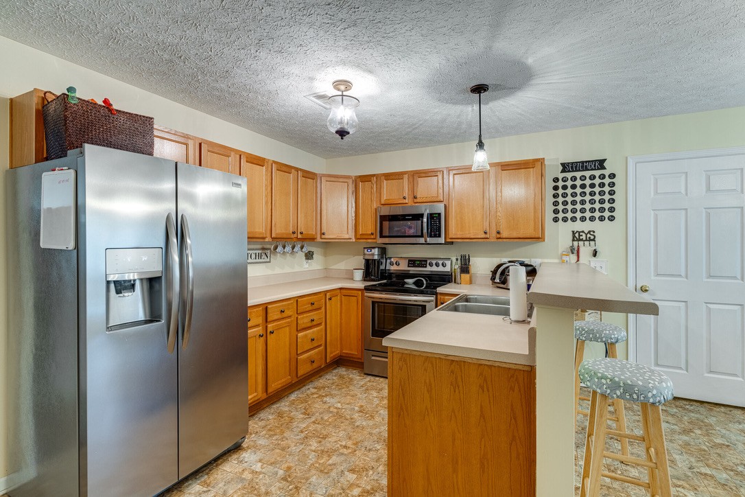 908 Chesire Court White House, TN 37188 - Photo 7 of 20 a kitchen with kitchen island granite countertop stainless steel appliances cabinets a sink and a counter top space