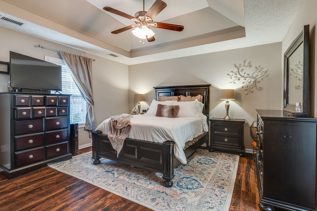908 Chesire Court White House, TN 37188 - Photo 10 of 20 a bedroom with a bed and a chandelier