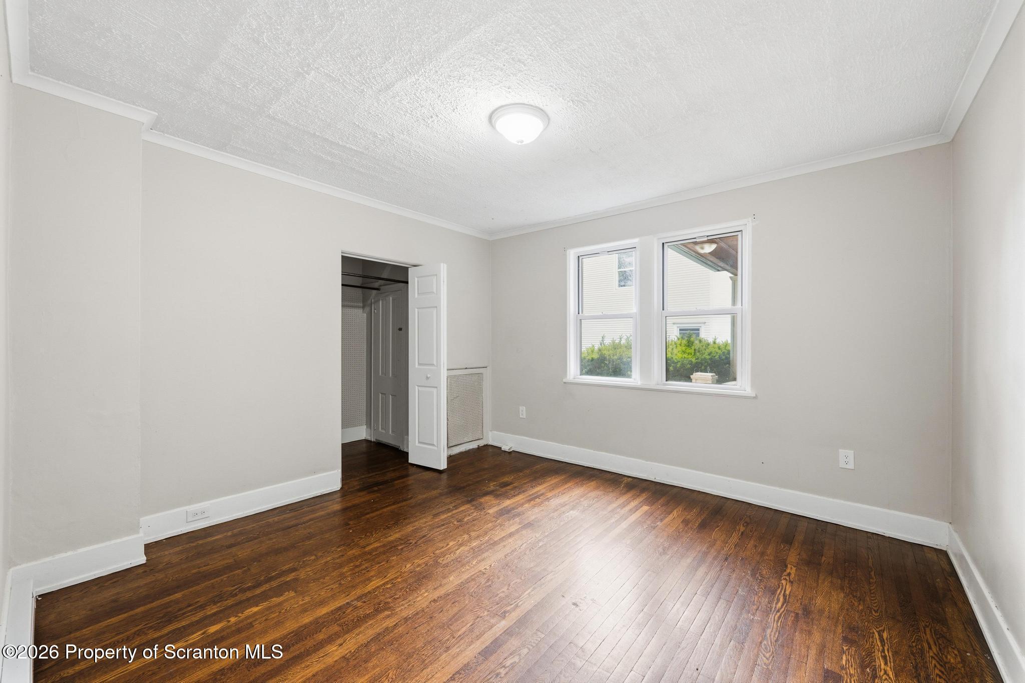433 Willow Street Scranton, PA 18505 - Photo 11 of 61 an empty room with wooden floor and windows