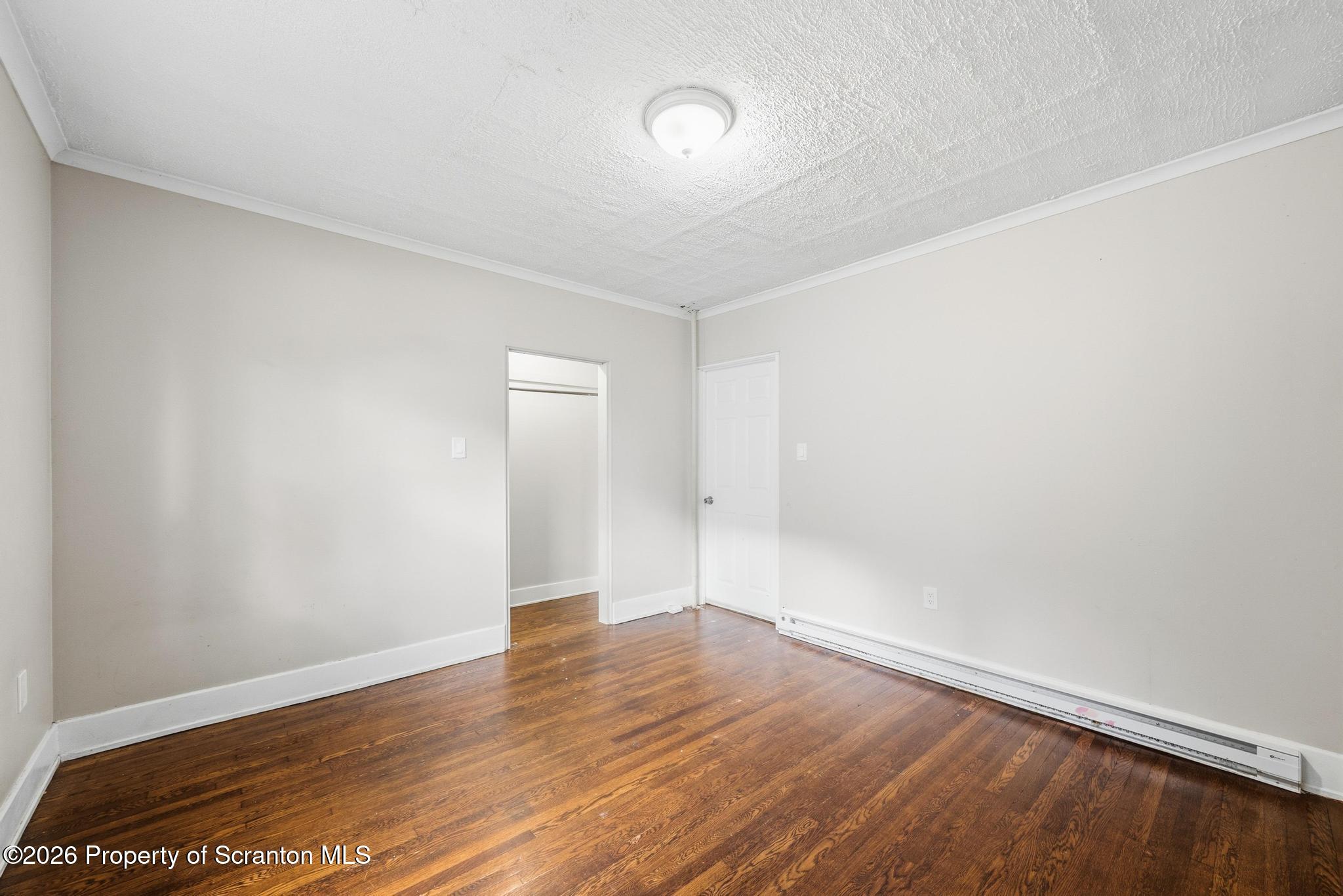 433 Willow Street Scranton, PA 18505 - Photo 12 of 61 a view of an empty room with wooden floor