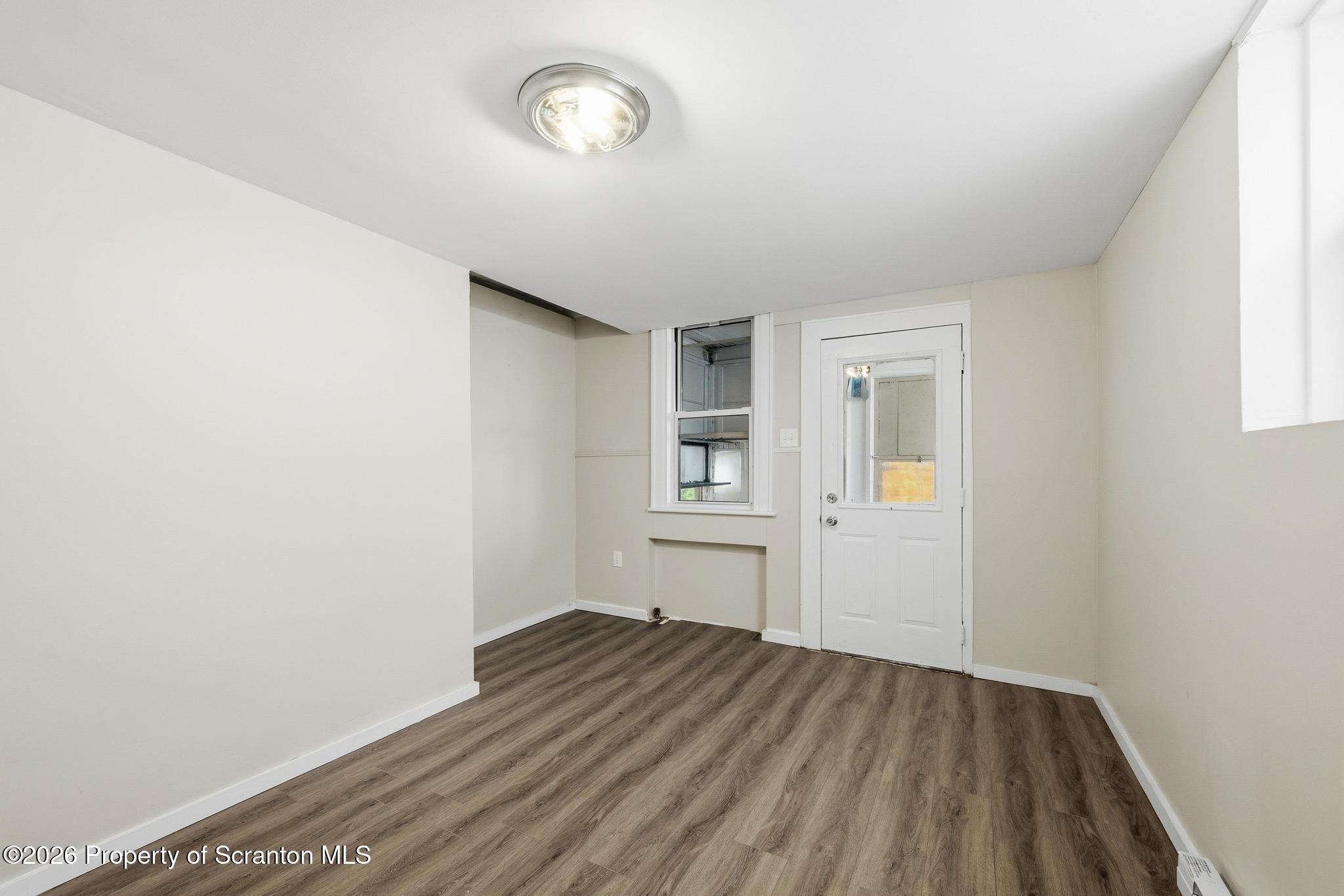 433 Willow Street Scranton, PA 18505 - Photo 13 of 61 an empty room with a hardwood and wooden floor