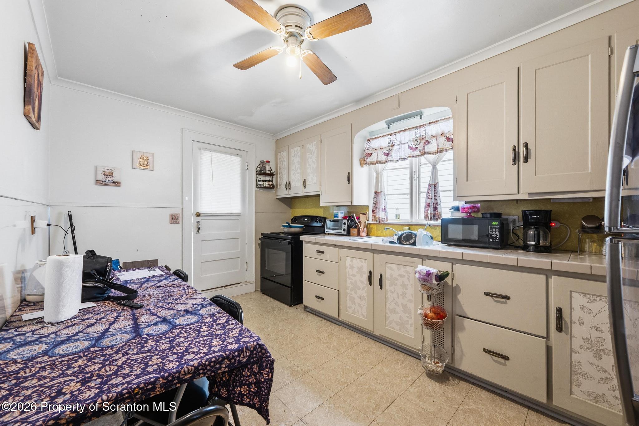 433 Willow Street Scranton, PA 18505 - Photo 20 of 61 a kitchen that has a lot of cabinets in it and appliances