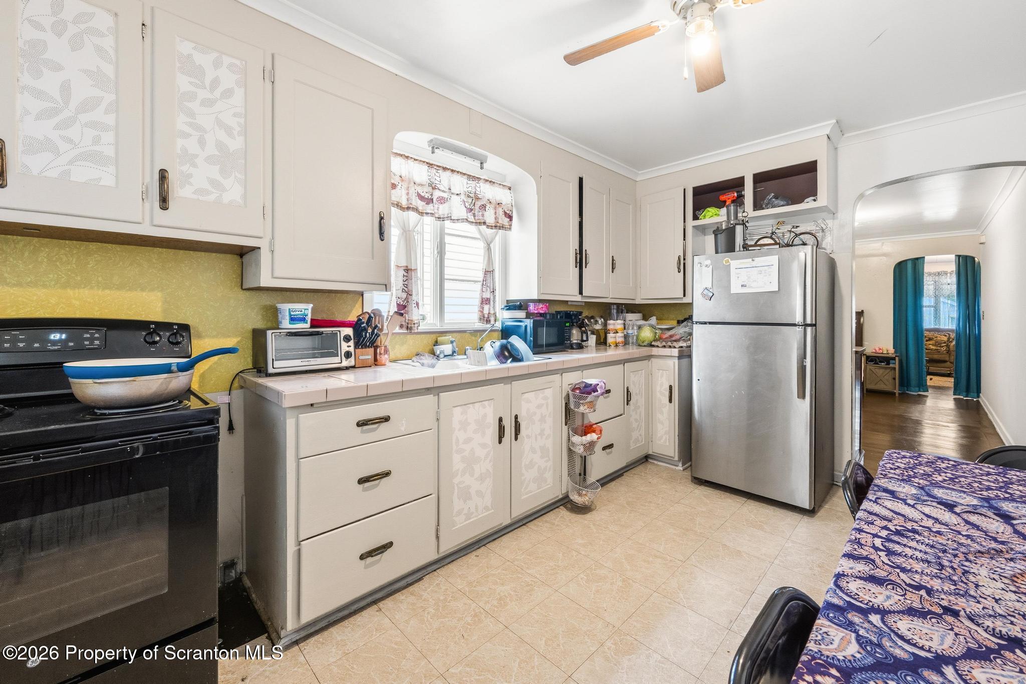 433 Willow Street Scranton, PA 18505 - Photo 22 of 61 a kitchen with refrigerator a stove a sink and cabinets