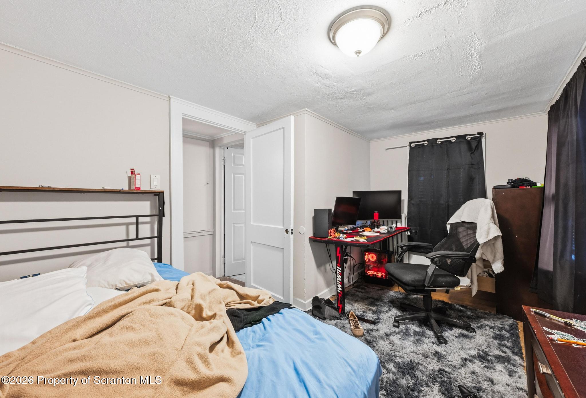 433 Willow Street Scranton, PA 18505 - Photo 38 of 61 a bedroom with a bed and wooden floor