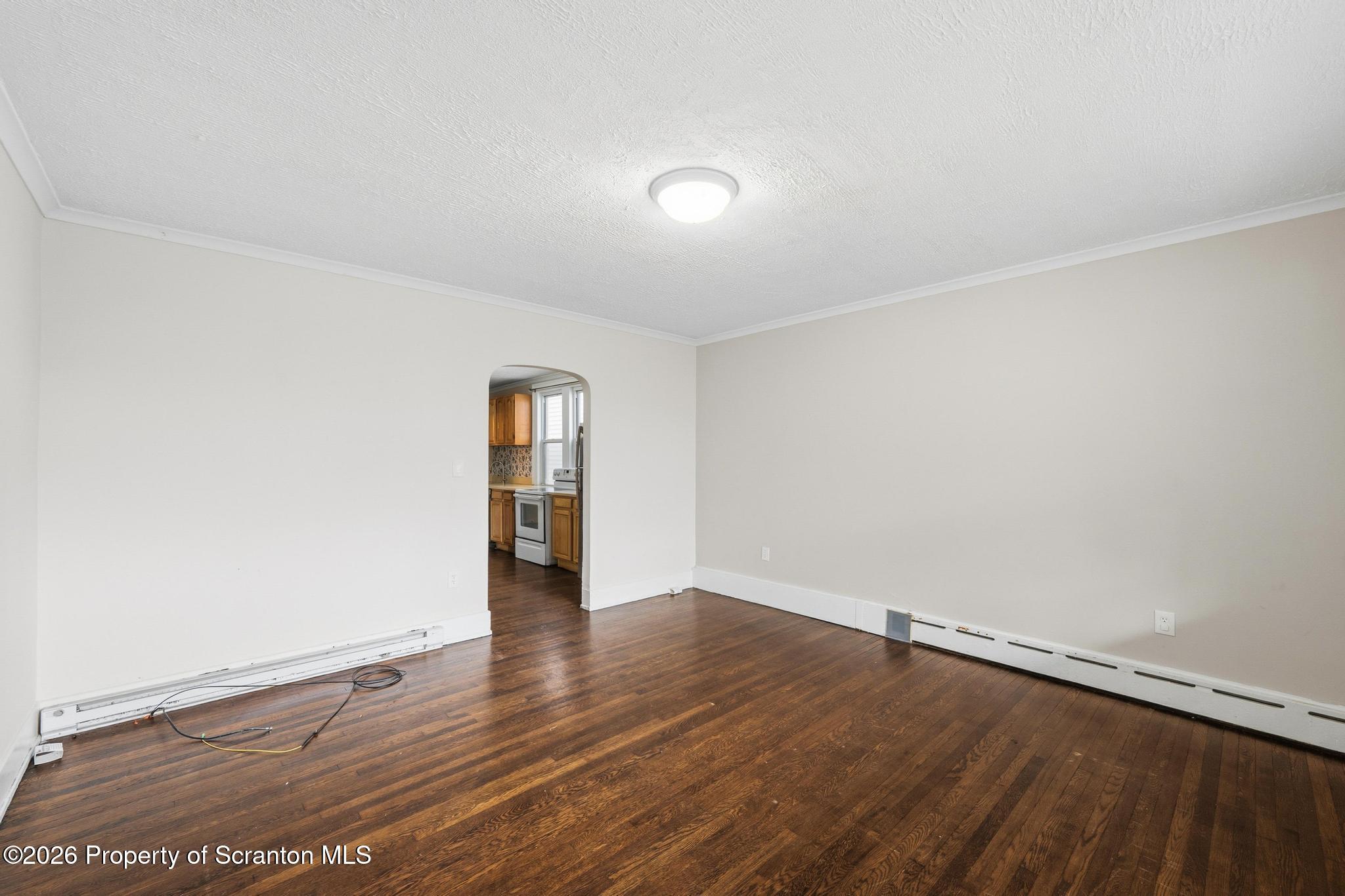 433 Willow Street Scranton, PA 18505 - Photo 4 of 61 a view of an empty room with wooden floor
