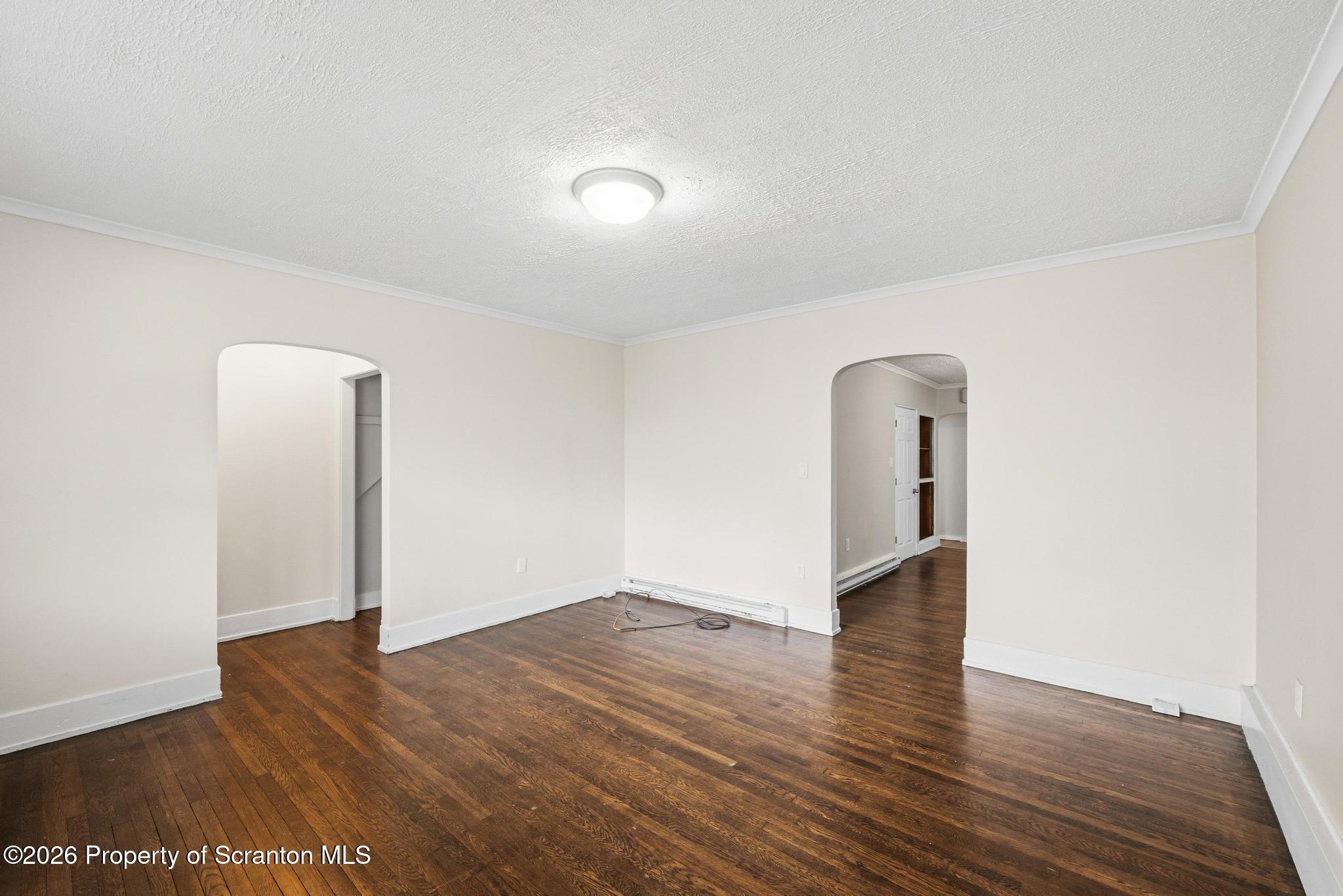 433 Willow Street Scranton, PA 18505 - Photo 5 of 61 an empty room with wooden floor and mirror