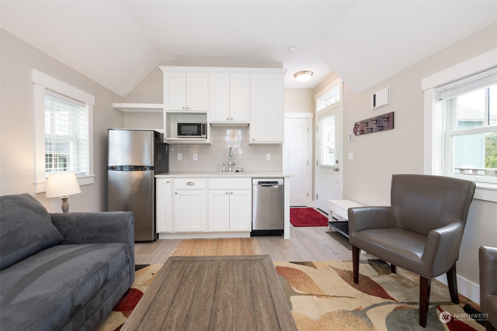 16 Barnhill Loop Pacific Beach, WA 98571 - Photo 26 of 31 a living room with stainless steel appliances furniture a flat screen tv and a window