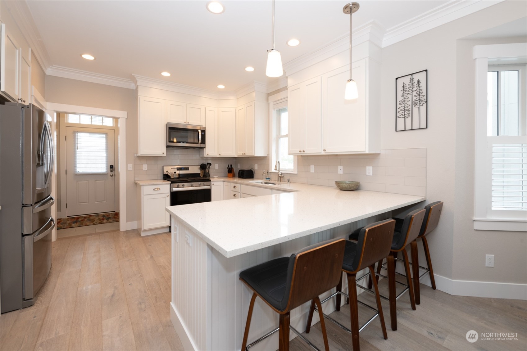 16 Barnhill Loop Pacific Beach, WA 98571 - Photo 7 of 31 a kitchen with kitchen island a stove a table and chairs
