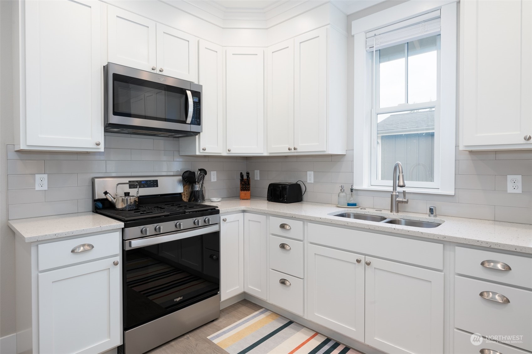 16 Barnhill Loop Pacific Beach, WA 98571 - Photo 8 of 31 a kitchen with white cabinets and white appliances