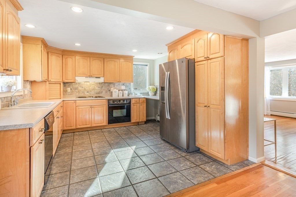 82 Wyman Road Billerica, MA 01821 - Photo 8 of 28 a kitchen with stainless steel appliances granite countertop a refrigerator and a sink