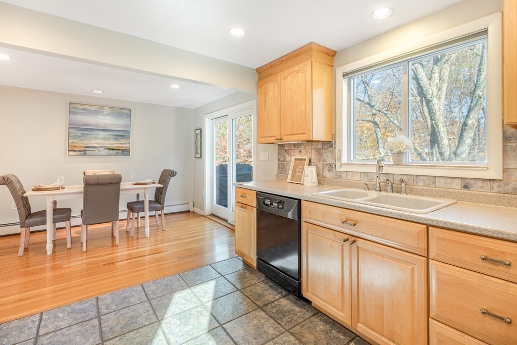 82 Wyman Road Billerica, MA 01821 - Photo 10 of 28 a dining hall with stainless steel appliances granite countertop a coffee table a sink and a window
