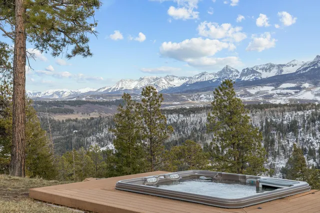 a view of a roof deck with table and chairs and couches