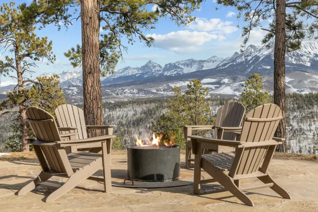 a living room with furniture and floor to ceiling windows