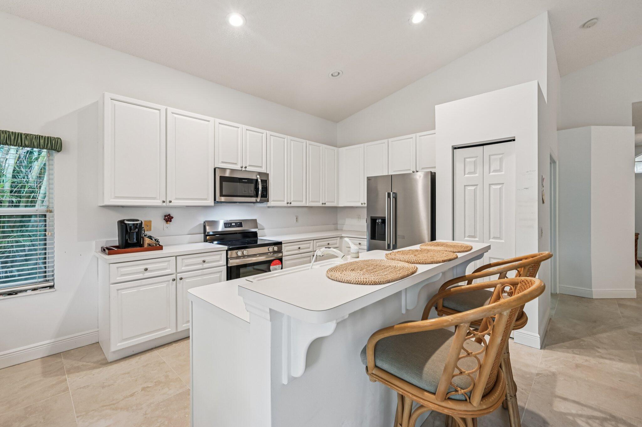 7184 Southeast Magellan Lane Stuart, FL 34997 - Photo 12 of 34 a kitchen that has a cabinets and a dining table chair