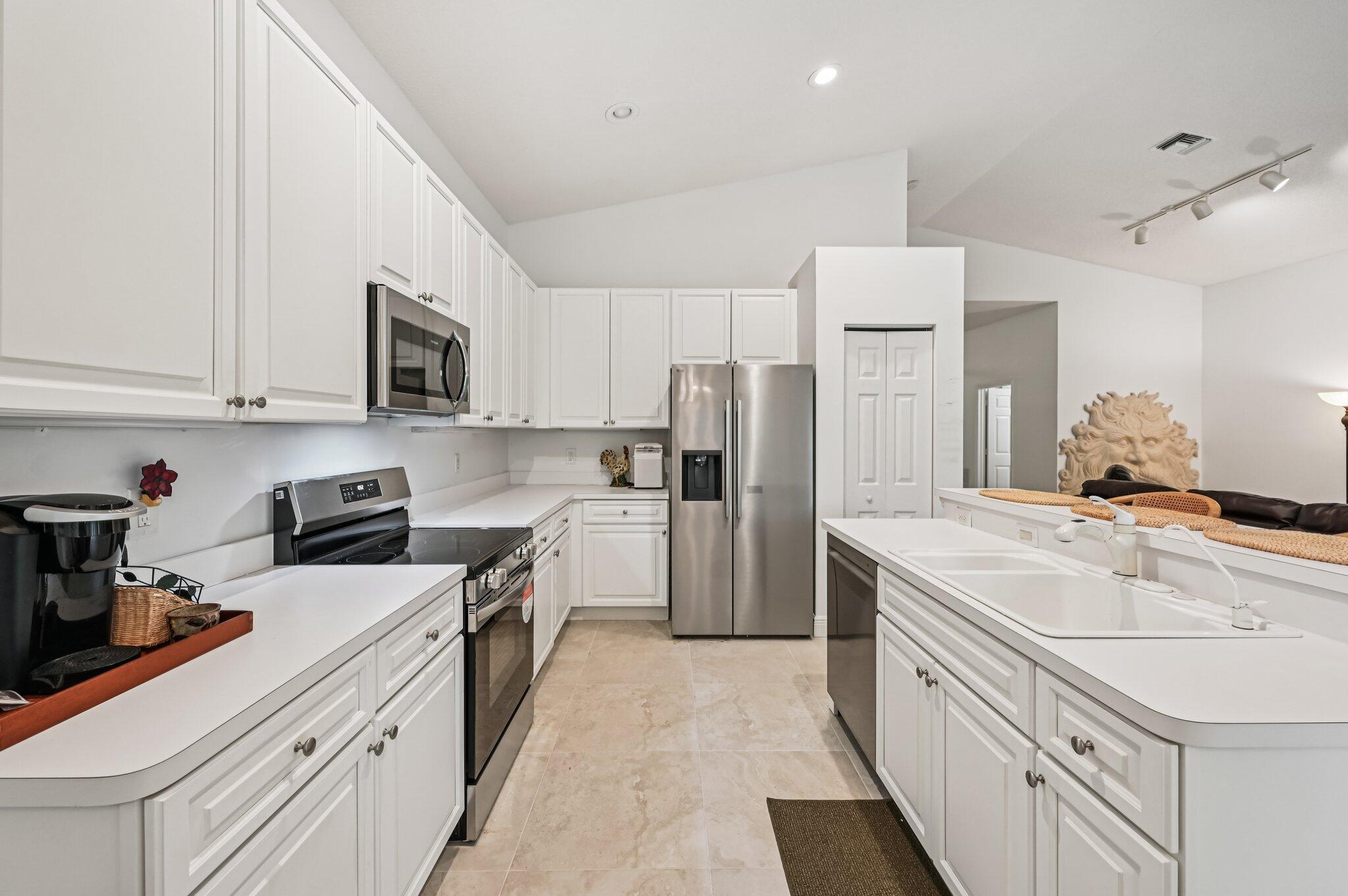 7184 Southeast Magellan Lane Stuart, FL 34997 - Photo 15 of 34 a kitchen with a sink stove and refrigerator