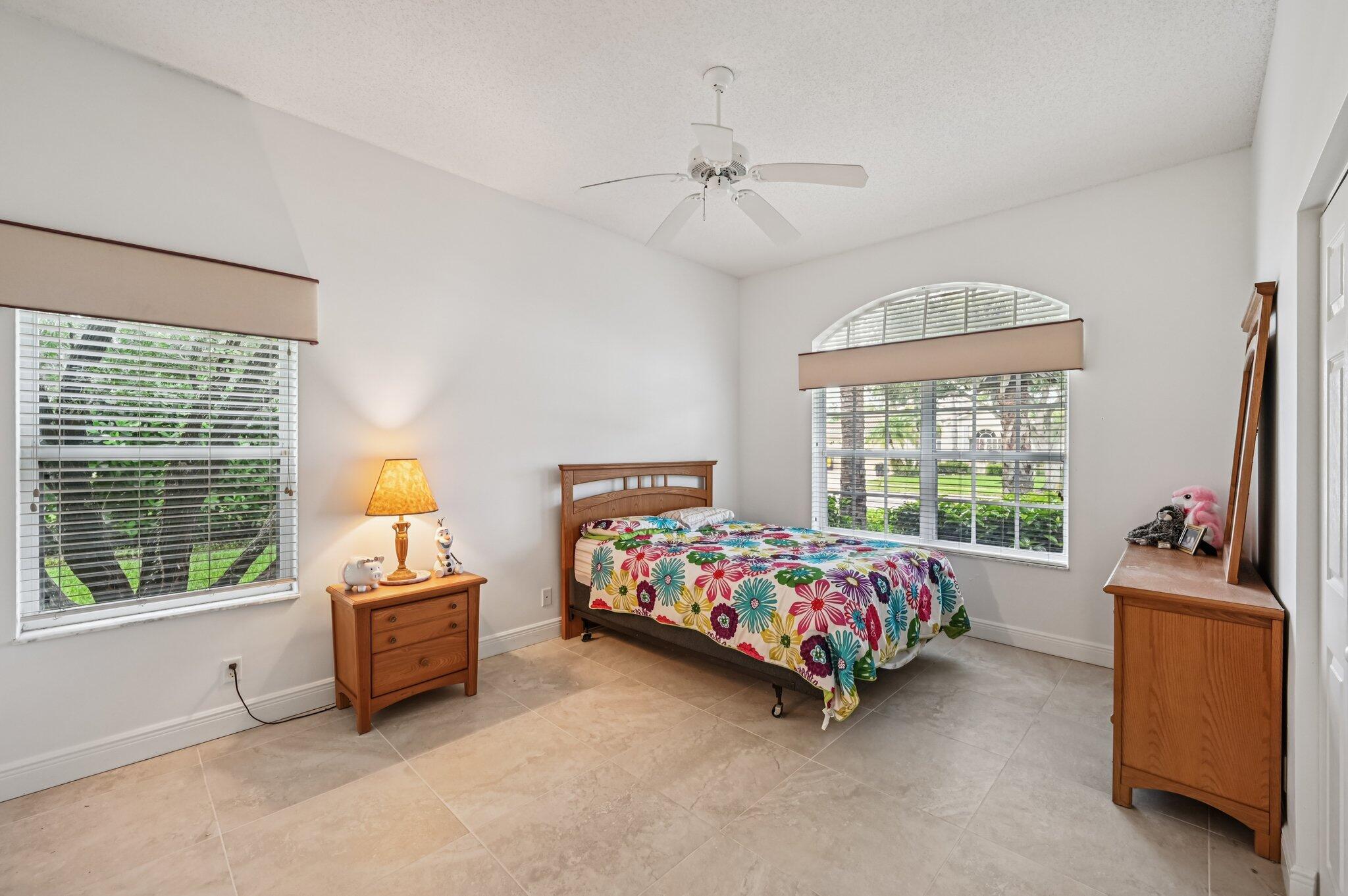 7184 Southeast Magellan Lane Stuart, FL 34997 - Photo 16 of 34 a bedroom with bed and a window