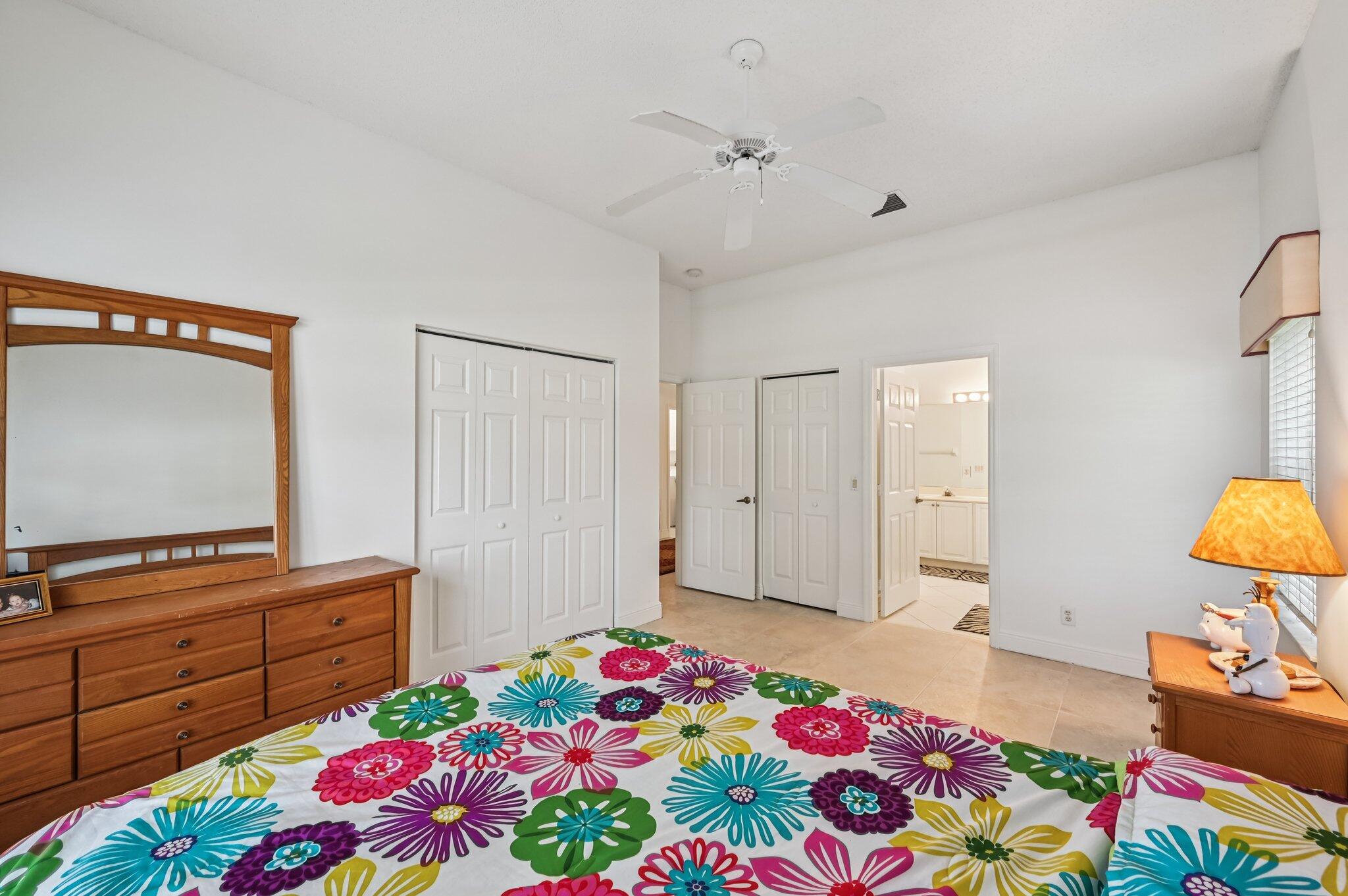 7184 Southeast Magellan Lane Stuart, FL 34997 - Photo 17 of 34 a bedroom with a bed and a dresser in it