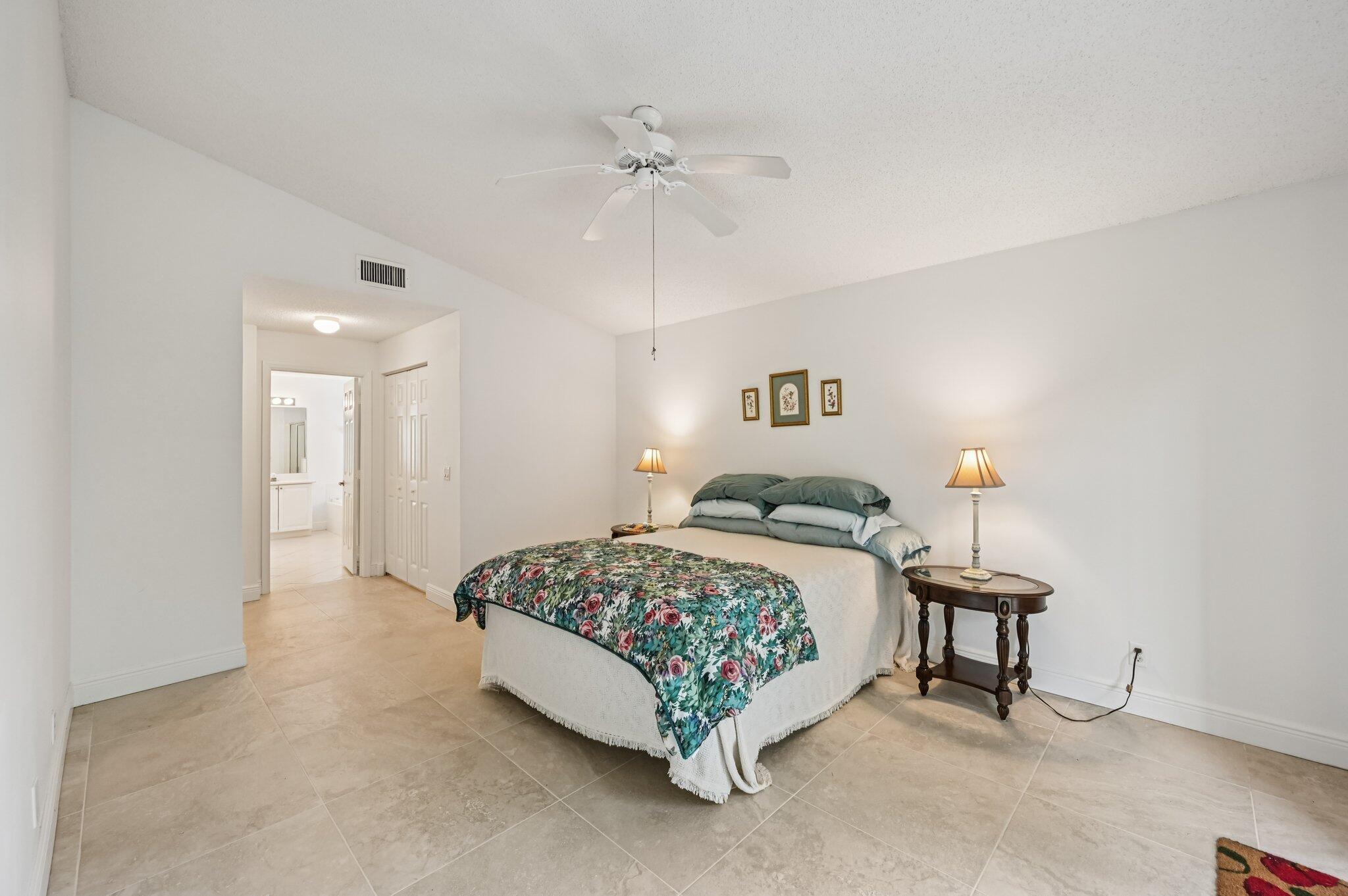 7184 Southeast Magellan Lane Stuart, FL 34997 - Photo 23 of 34 a bed room with a bed and a lamp