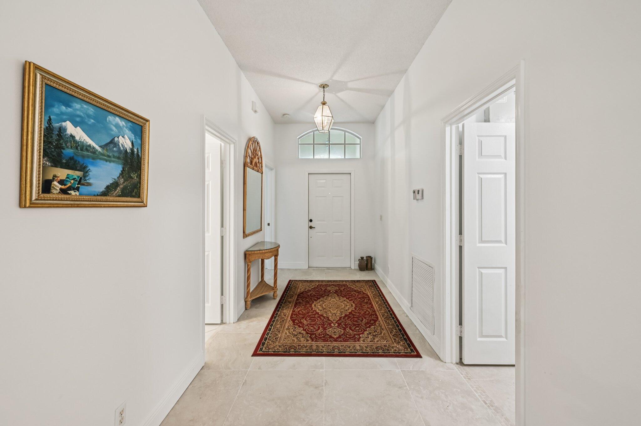 7184 Southeast Magellan Lane Stuart, FL 34997 - Photo 6 of 34 a room that has a bed in it and a chandelier