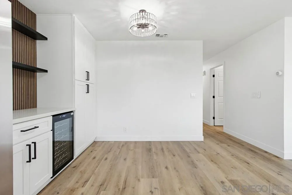4379 Albatross Way Oceanside, CA 92057 - Photo 12 of 44 an empty room with wooden floor and cabinet