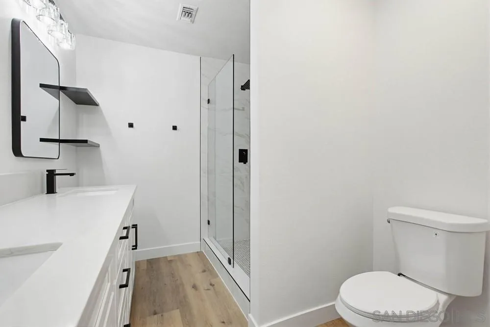4379 Albatross Way Oceanside, CA 92057 - Photo 23 of 44 a bathroom with a sink a toilet and shower