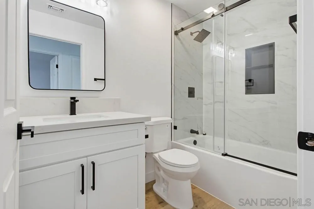 4379 Albatross Way Oceanside, CA 92057 - Photo 29 of 44 a bathroom with a sink a toilet and shower