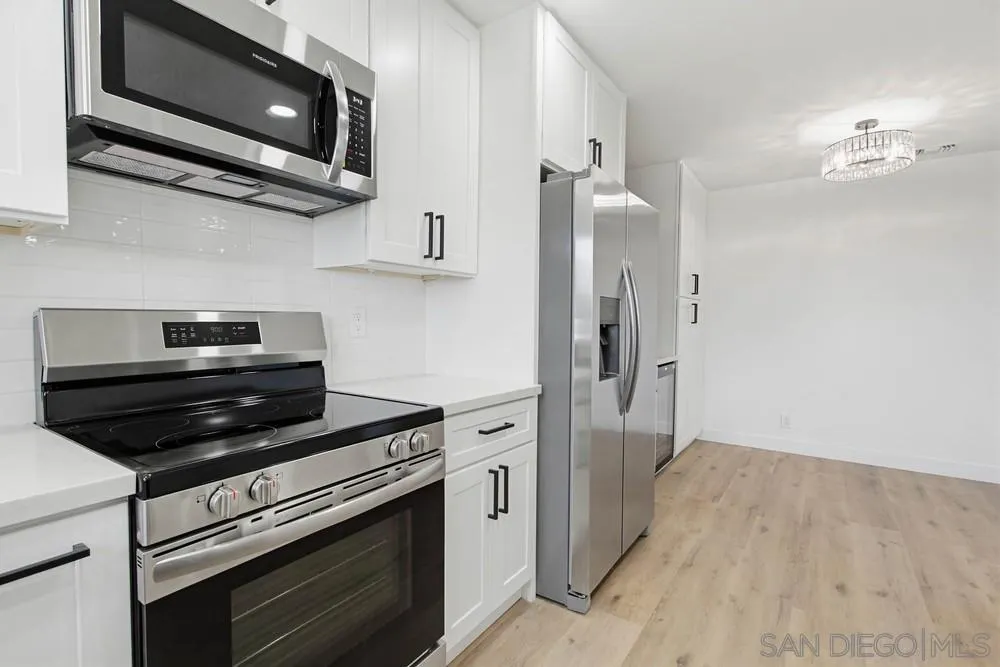 4379 Albatross Way Oceanside, CA 92057 - Photo 3 of 44 a kitchen with cabinets and steel stainless steel appliances