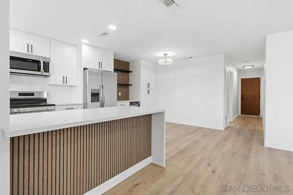 4379 Albatross Way Oceanside, CA 92057 - Photo 4 of 44 a kitchen with stainless steel appliances a refrigerator and a stove top oven