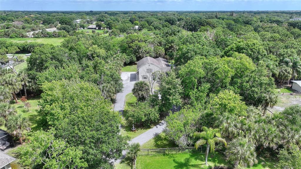 3641 Turtle Mound Road Melbourne, FL 32934 - Photo 68 of 77 an aerial view of a house with a yard and large tree