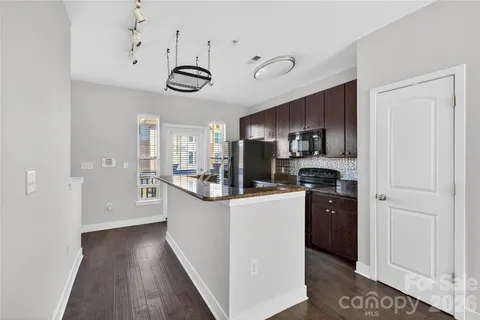 a view of kitchen with microwave and refrigerator