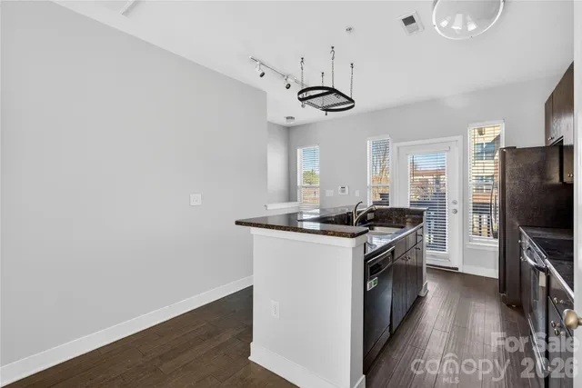 a kitchen with stainless steel appliances a stove a sink and a refrigerator