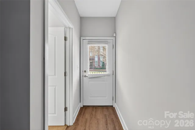 a view of hallway with wooden floor