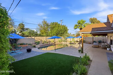 a view of a backyard with a patio and fire pit