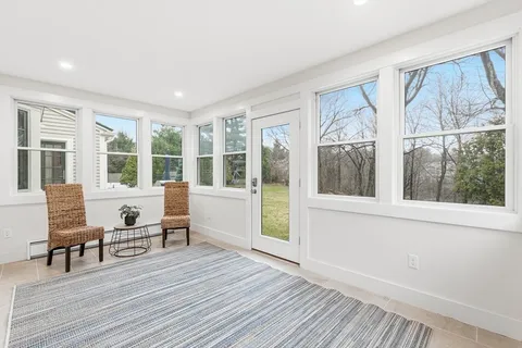 a view of a work space with wooden floor and windows