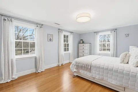 a bedroom with a large bed closet and window