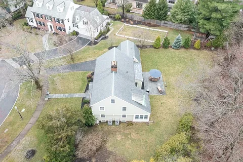an aerial view of a house with a yard