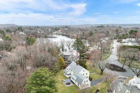 an aerial view of a house with a lake view