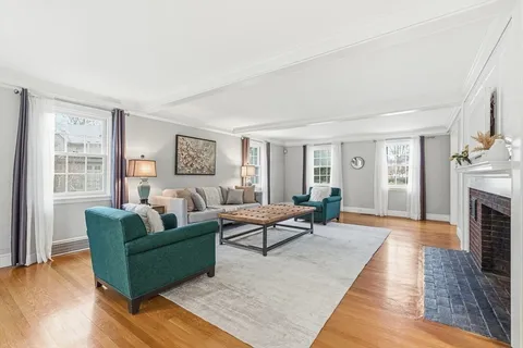 a living room with fireplace furniture and a wooden floor