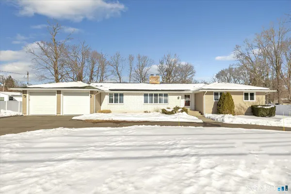 a view of a house with a yard and many windows