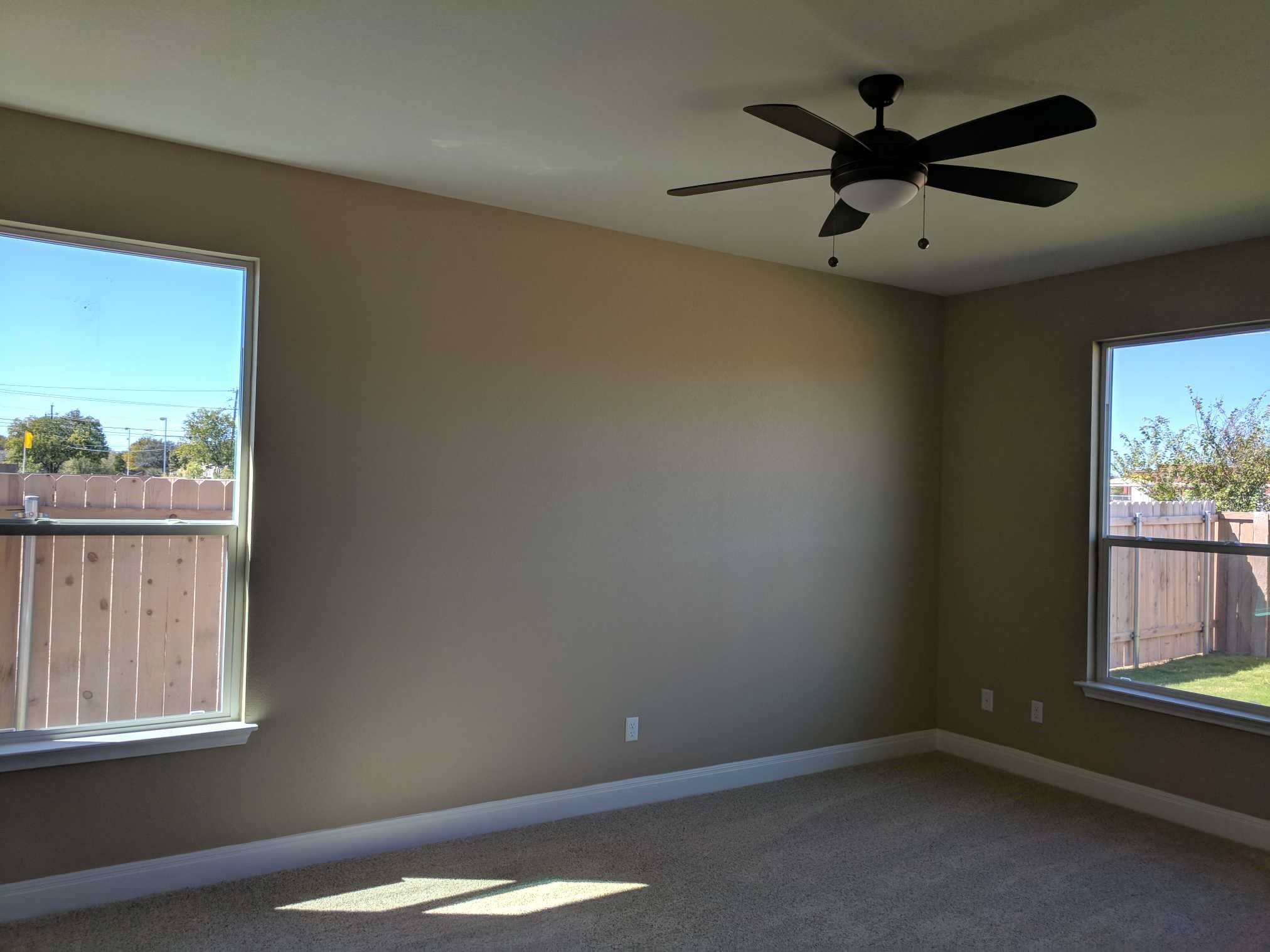 2471 Sunrise Road, Unit 8 Round Rock, TX 78664 - Photo 4 of 13 Spacious room featuring neutral-toned walls, carpeted flooring, and a ceiling fan with integrated lighting