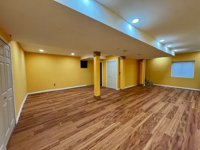 a view of a room with wooden floor