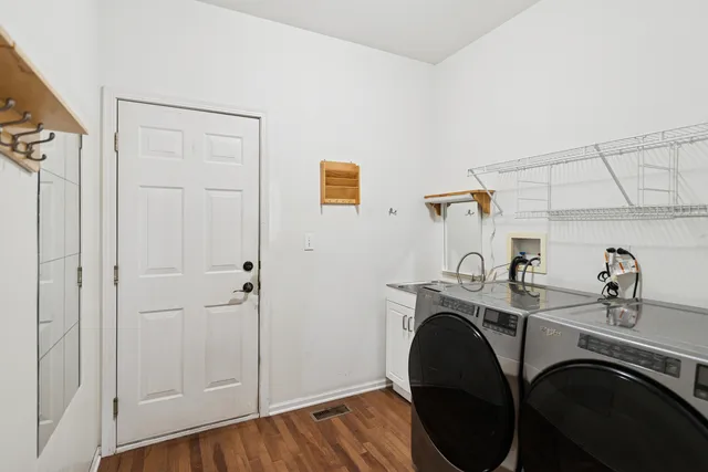 a utility room with sink dryer and washer