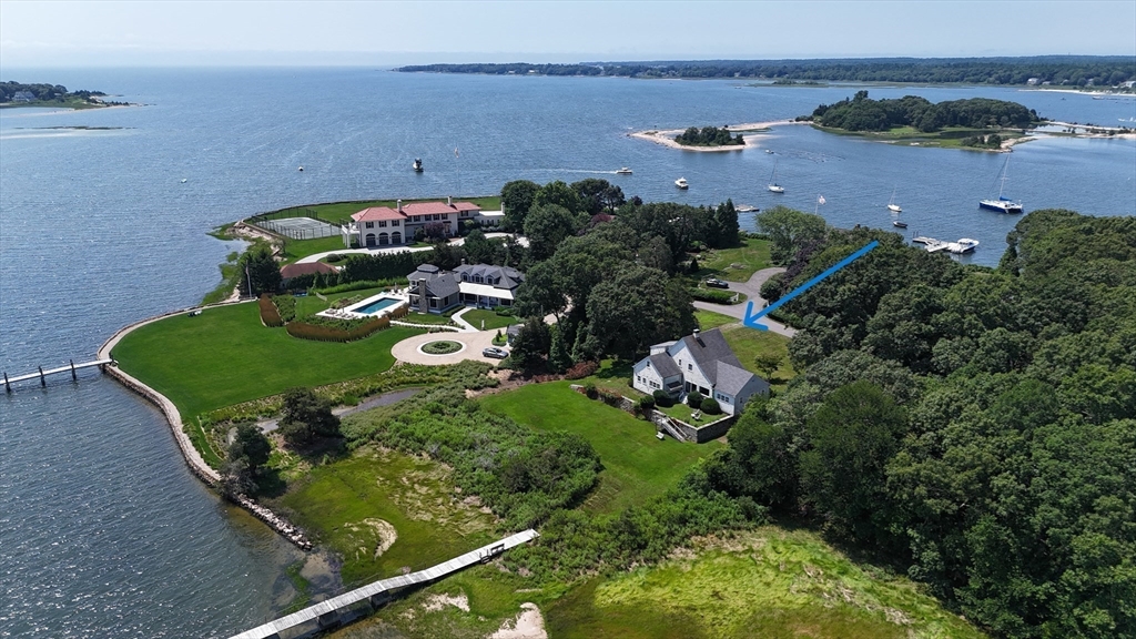 an aerial view of a house with a yard basket ball court and outdoor seating